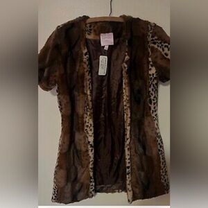 This is a Romeo & Juliet Couture faux fur jacket. The jacket is cheetah themed
